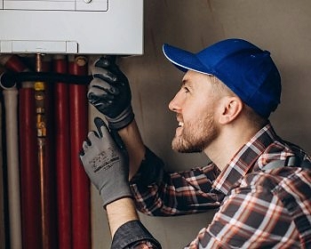 service-man-adjusting-house-heating-system_1303-26529